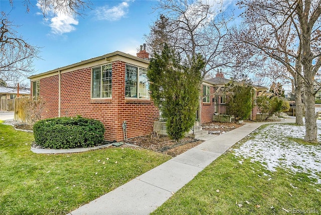 view of side of property with a yard