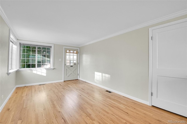 interior space featuring ornamental molding and light wood-type flooring