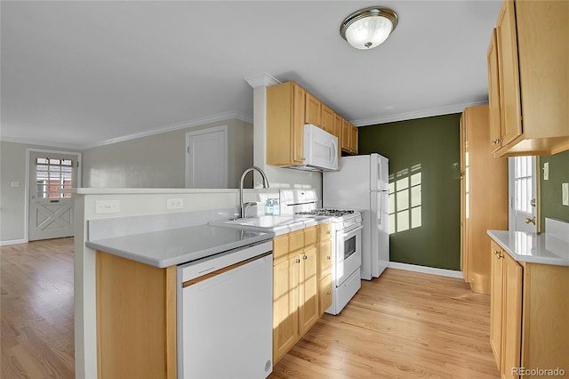 kitchen with sink, light hardwood / wood-style flooring, kitchen peninsula, crown molding, and white appliances