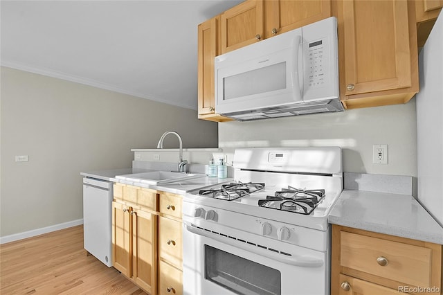 kitchen with light stone countertops, sink, light hardwood / wood-style floors, white appliances, and ornamental molding