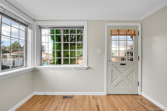 entryway featuring light hardwood / wood-style flooring and ornamental molding