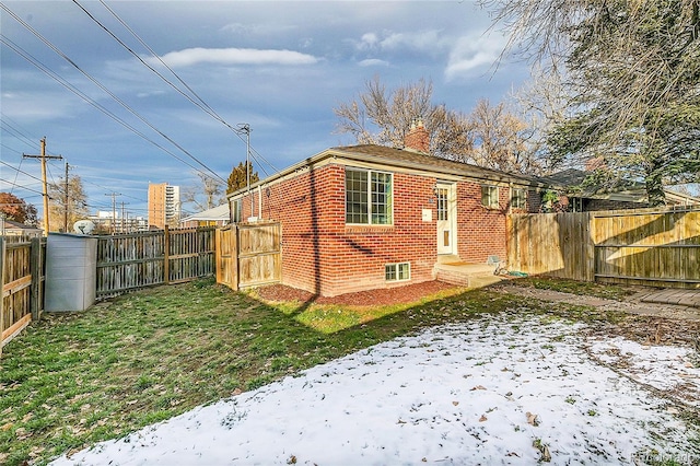 rear view of property with a yard