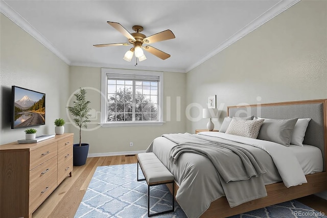 bedroom with baseboards, ceiling fan, crown molding, and light wood finished floors