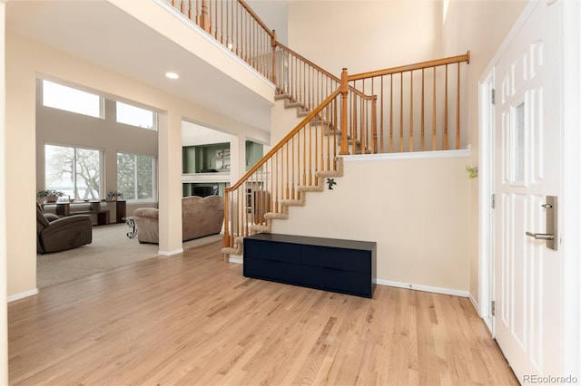 4814 S Upham Ct, Littleton, CO 80123 - stairway featuring a high ceiling, wood finished floors, and recessed lighting
