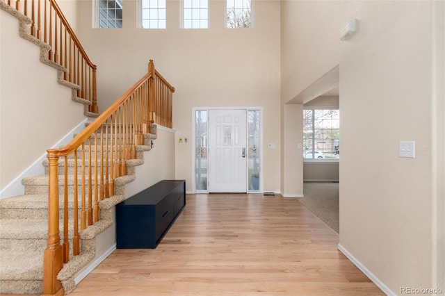 4814 S Upham Ct, Littleton, CO 80123 - foyer with a high ceiling, stairway, and wood finished floors