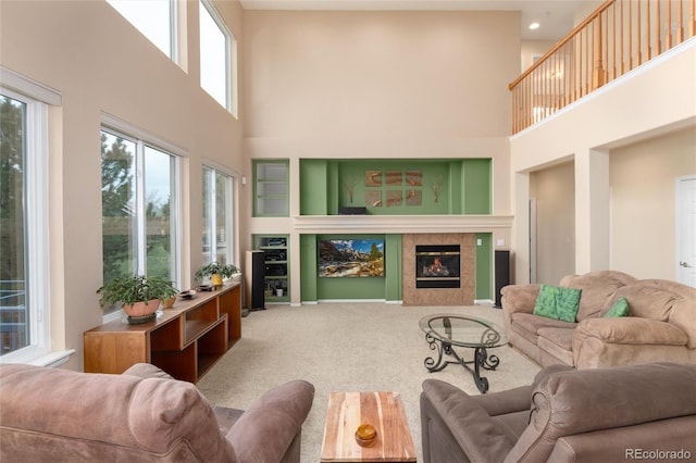 4814 S Upham Ct, Littleton, CO 80123 - carpeted living room with a high ceiling and a tile fireplace