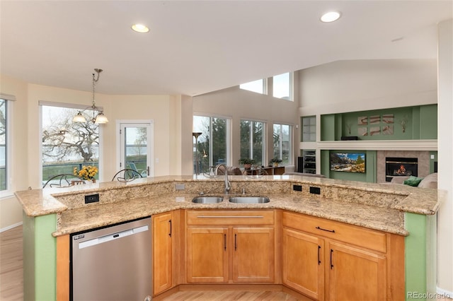 4814 S Upham Ct, Littleton, CO 80123 - kitchen featuring stainless steel dishwasher, light stone counters, healthy amount of natural light, light wood-style floors, and recessed lighting