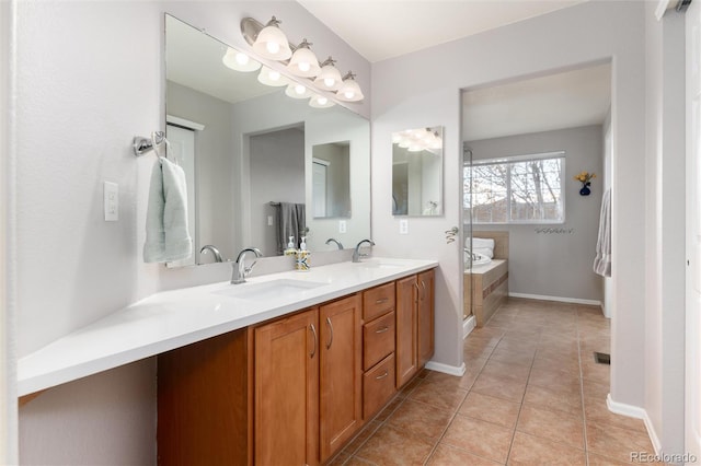4814 S Upham Ct, Littleton, CO 80123 - bathroom featuring double vanity, tile patterned flooring, and a tub