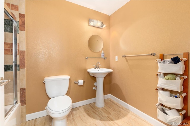 4814 S Upham Ct, Littleton, CO 80123 - bathroom with toilet and shower / bath combination with glass door