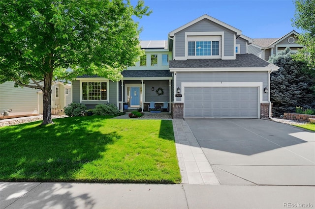 4814 S Upham Ct, Littleton, CO 80123 - view of front of property featuring roof mounted solar panels, driveway, a front yard, a garage, and covered porch