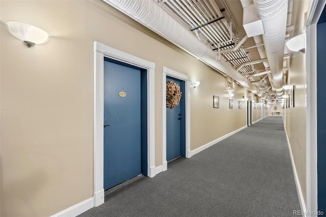 hall featuring carpet floors and baseboards
