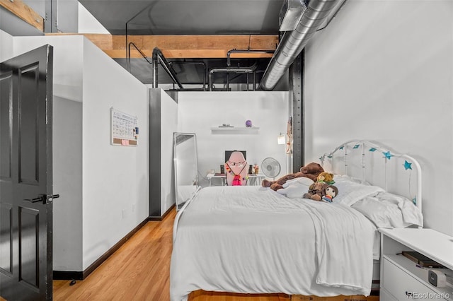 bedroom with baseboards and light wood-type flooring