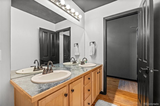 full bathroom with a sink and wood finished floors