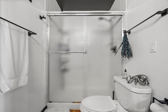 full bath featuring toilet and a shower stall