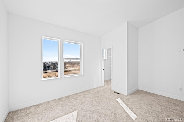 unfurnished room with light colored carpet