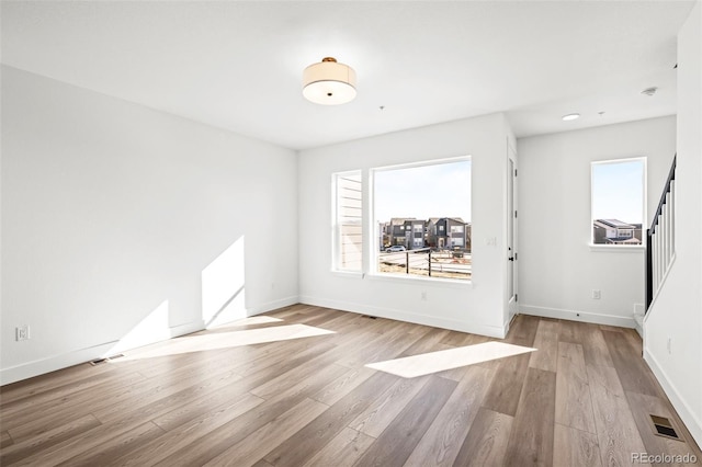 unfurnished room with light wood-type flooring