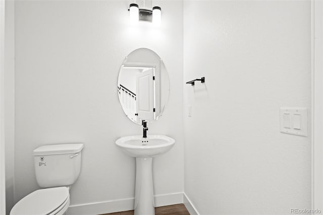 bathroom with wood-type flooring and toilet