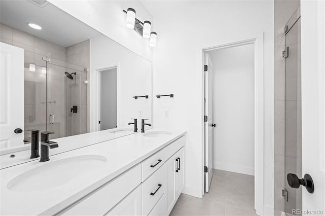 bathroom with tile patterned floors, vanity, and a shower with door