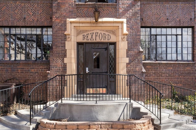 property entrance featuring brick siding