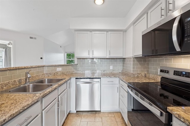 11 W Ellsworth Ave Unit 22, Denver, CO 80223 - kitchen featuring appliances with stainless steel finishes, a sink, backsplash, white cabinetry, and light stone countertops