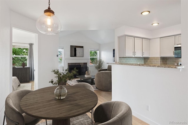 11 W Ellsworth Ave Unit 22, Denver, CO 80223 - dining room with light wood-style flooring and a fireplace with raised hearth