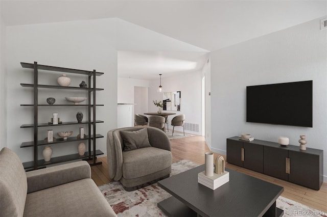 11 W Ellsworth Ave Unit 22, Denver, CO 80223 - living area with light wood-type flooring, vaulted ceiling, and baseboards