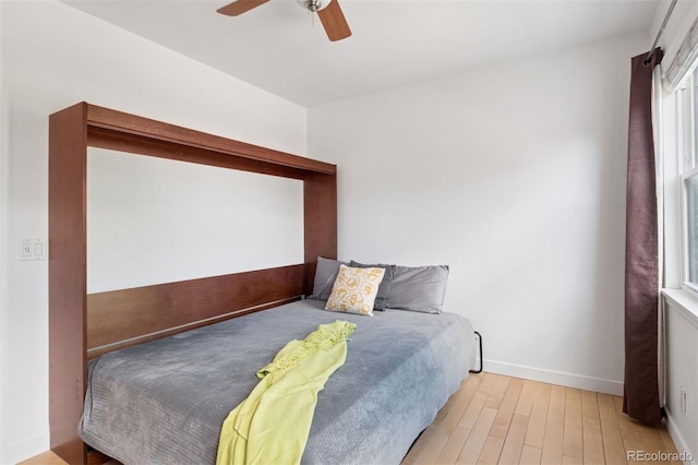 11 W Ellsworth Ave Unit 22, Denver, CO 80223 - bedroom with light wood-style floors, baseboards, and a ceiling fan