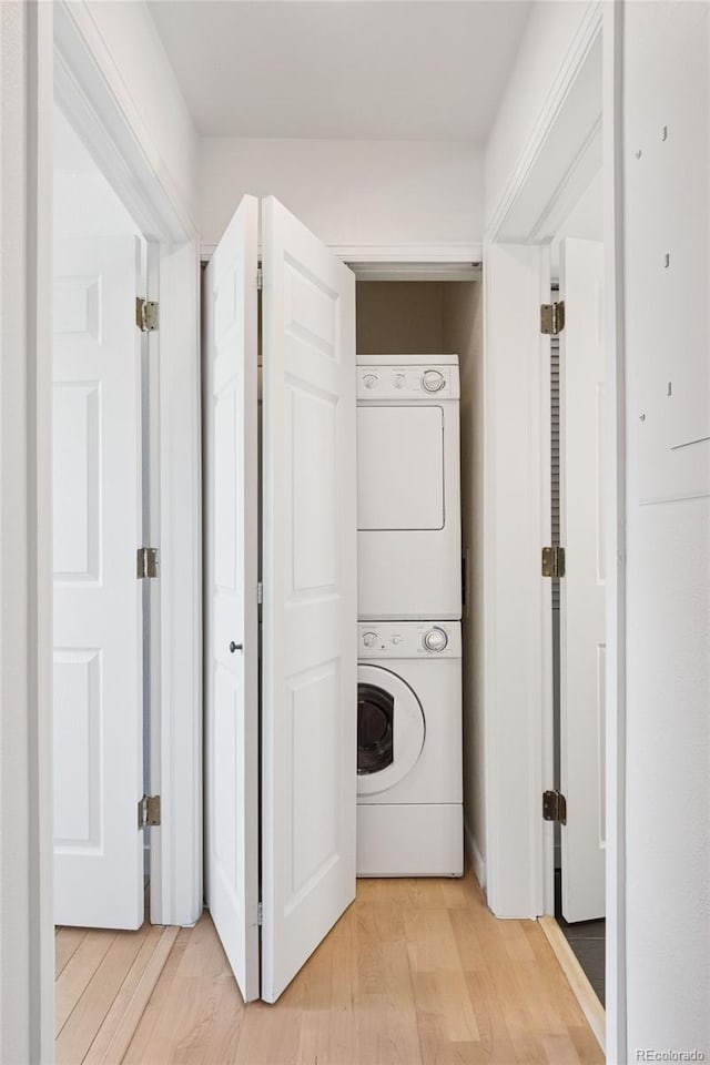 11 W Ellsworth Ave Unit 22, Denver, CO 80223 - laundry room with stacked washing machine and dryer and light wood-style flooring