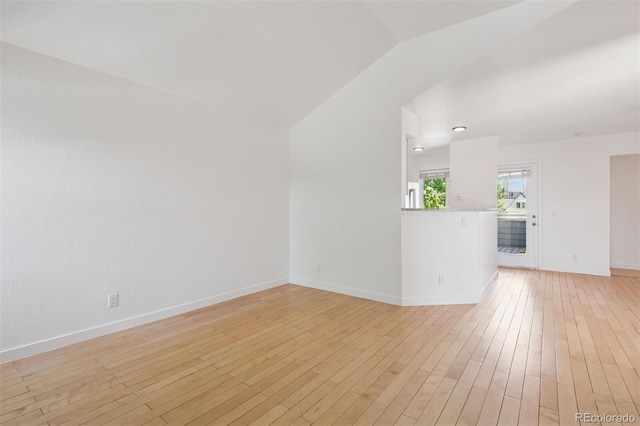 11 W Ellsworth Ave Unit 22, Denver, CO 80223 - unfurnished living room with light wood-style floors, baseboards, and vaulted ceiling