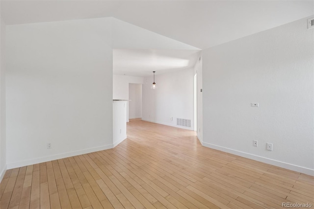 11 W Ellsworth Ave Unit 22, Denver, CO 80223 - empty room featuring light wood-style floors, baseboards, and vaulted ceiling