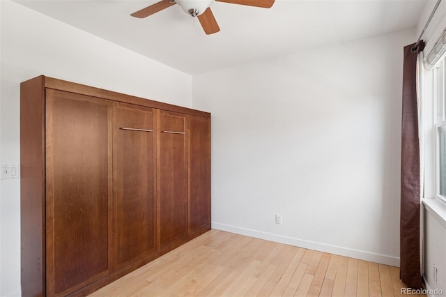 11 W Ellsworth Ave Unit 22, Denver, CO 80223 - unfurnished bedroom with light wood finished floors, baseboards, and a ceiling fan