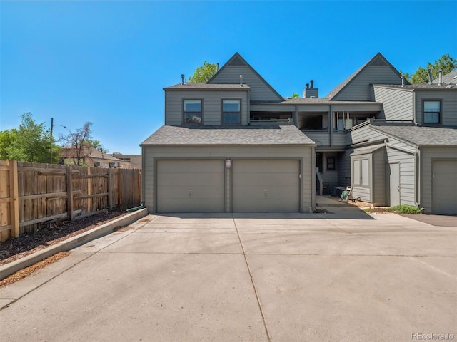 11 W Ellsworth Ave Unit 22, Denver, CO 80223 - view of front of home with driveway and roof with shingles