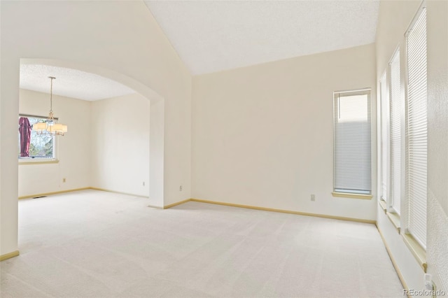 14084 E Hampden Pl, Aurora, CO 80014 - unfurnished room with a chandelier, light carpet, arched walkways, and baseboards