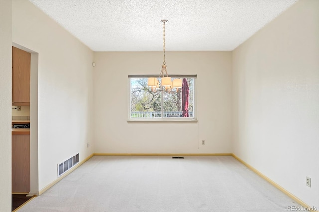 14084 E Hampden Pl, Aurora, CO 80014 - unfurnished dining area featuring baseboards, a notable chandelier, visible vents, and carpet