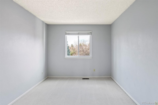 14084 E Hampden Pl, Aurora, CO 80014 - spare room featuring baseboards, light carpet, visible vents, and a textured ceiling