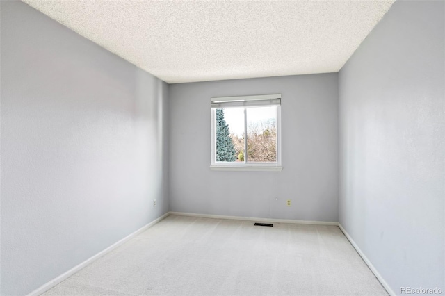 14084 E Hampden Pl, Aurora, CO 80014 - unfurnished room featuring a textured ceiling, carpet floors, baseboards, and visible vents