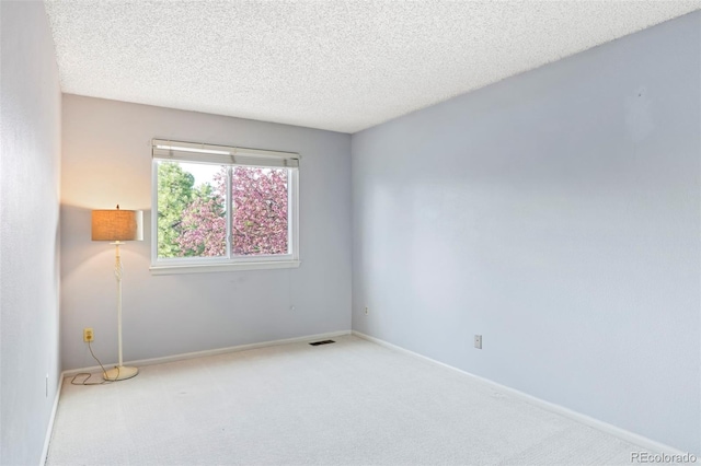 14084 E Hampden Pl, Aurora, CO 80014 - spare room with a textured ceiling, carpet, baseboards, and visible vents