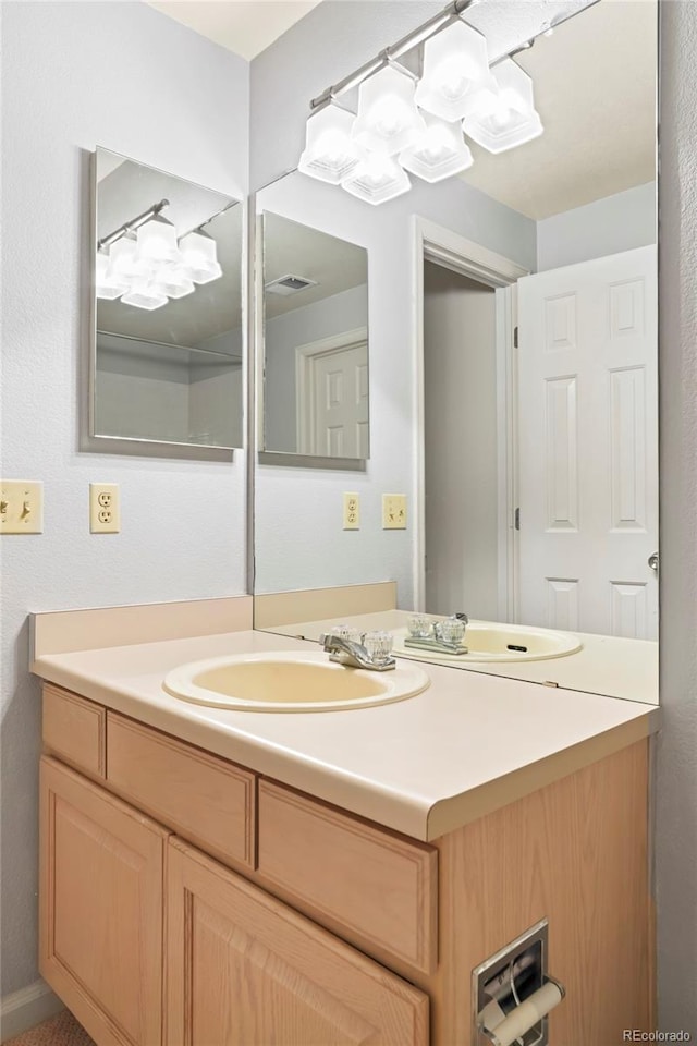 14084 E Hampden Pl, Aurora, CO 80014 - bathroom with an inviting chandelier, visible vents, and vanity