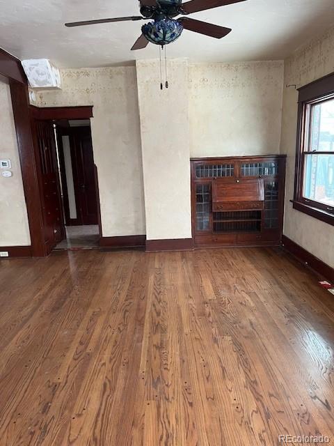 unfurnished living room featuring hardwood / wood-style floors and a tile fireplace