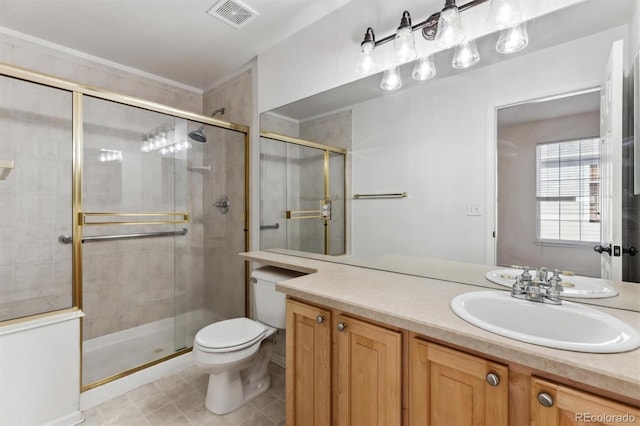 bathroom featuring vanity, a shower with door, and toilet