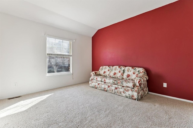 living area with lofted ceiling and carpet flooring