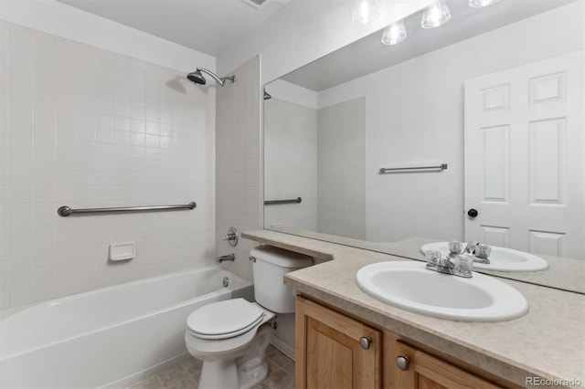 full bathroom featuring vanity, tile patterned flooring, tiled shower / bath combo, and toilet