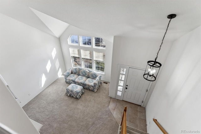 interior space featuring carpet flooring and high vaulted ceiling