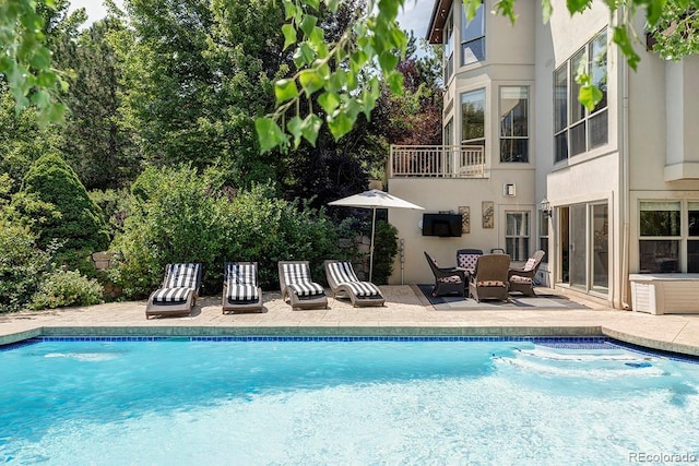 outdoor pool with a patio area