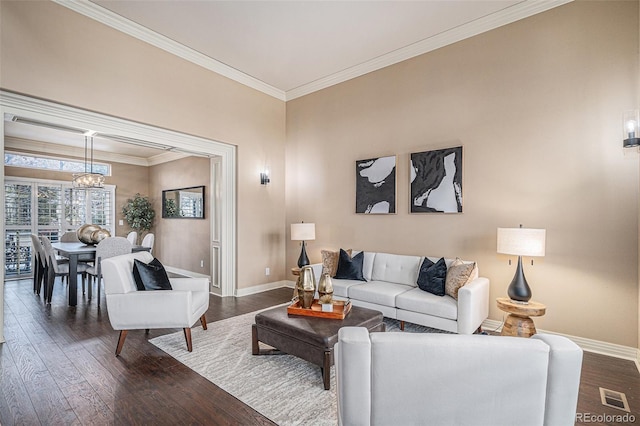 living room featuring ornamental molding, dark wood finished floors, visible vents, and baseboards