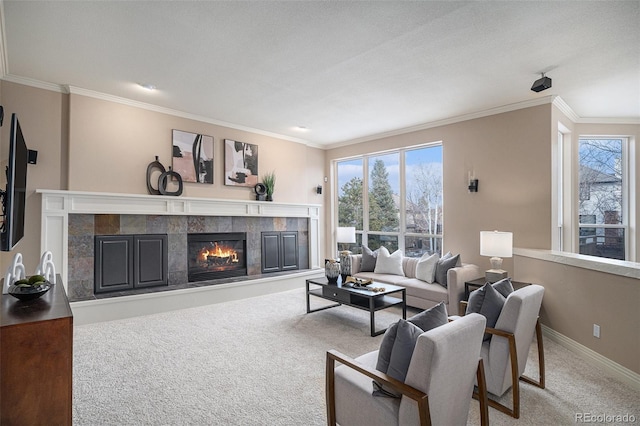 living area with baseboards, a fireplace, carpet flooring, and crown molding