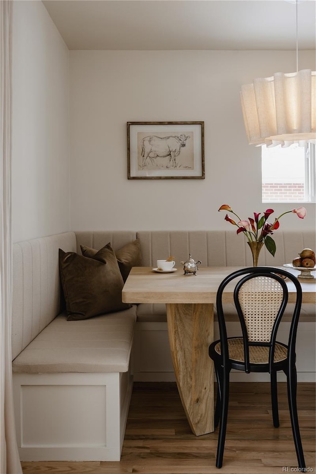 dining room featuring breakfast area and hardwood / wood-style floors