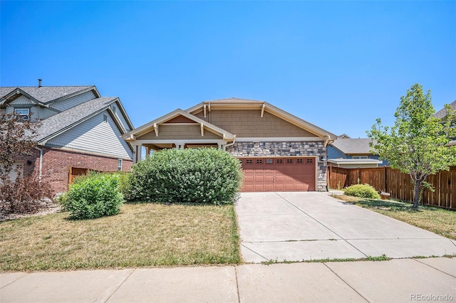 craftsman house featuring a front yard and a garage