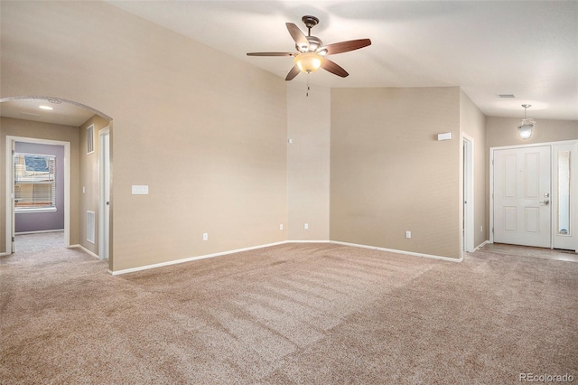 carpeted empty room with ceiling fan and lofted ceiling