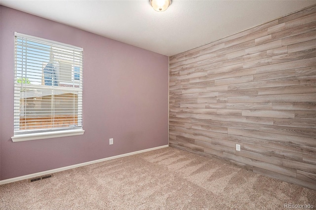 unfurnished room featuring carpet